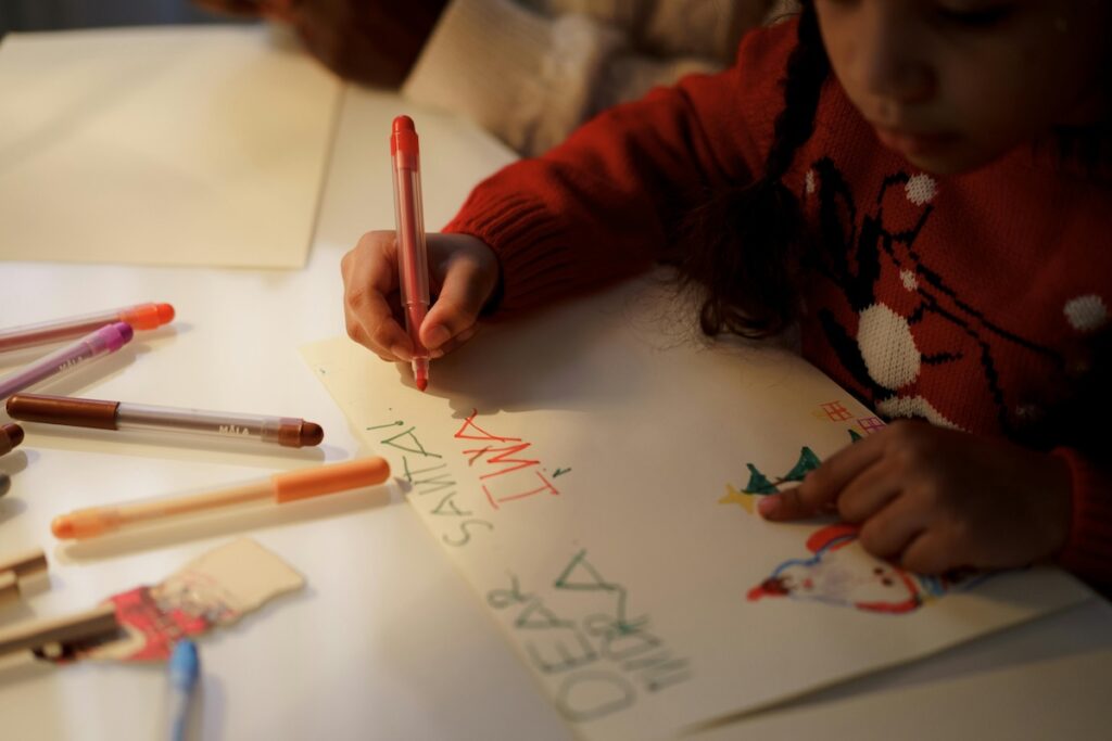 child writing a letter to french santa