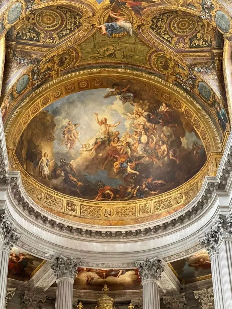 Spend One day at versailles – Baroque frescoed dome of the Royal Chapel at Versailles, illustrating biblical scenes surrounded by golden architectural detail.