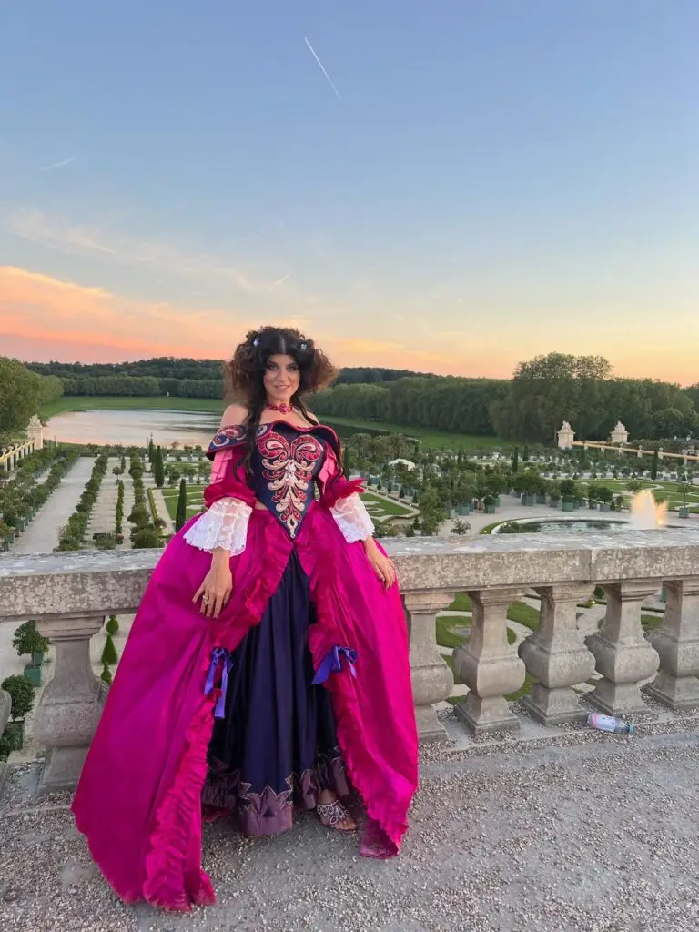 Tara Lengyel in costume, Versailles gardens in background