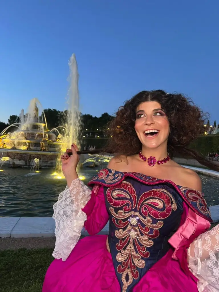 Tara Lengyel in costume, Versailles gardens in background