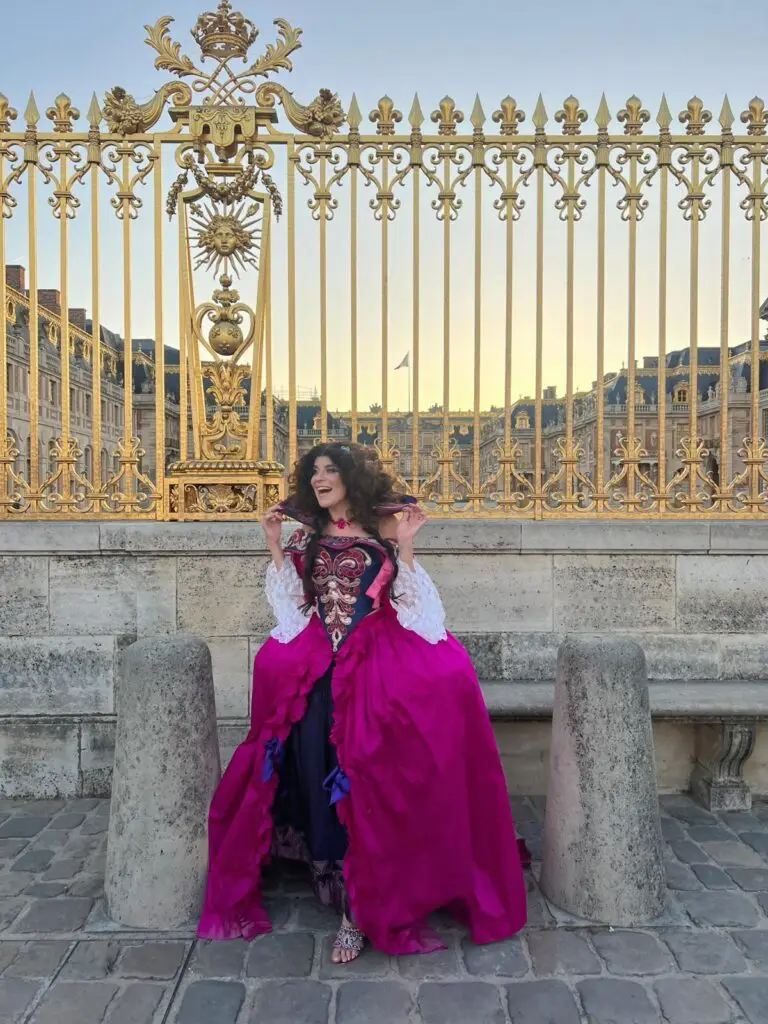 Tara Lengyel in costume, Versailles gates in background